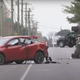 A photo of a red sedan and police cruiser hit by a backhoe